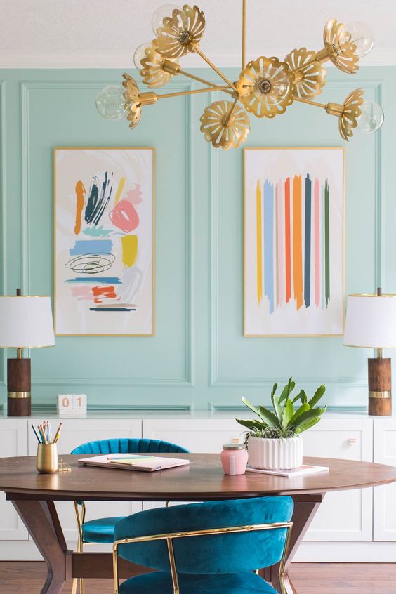 pastel blue dining room with abstract art and vintage sideboard