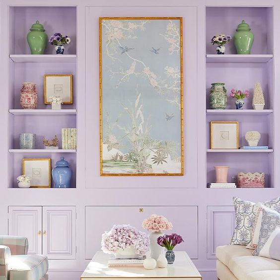 image of pastel coloured home interior with lilac bookshelf and coffee table styling