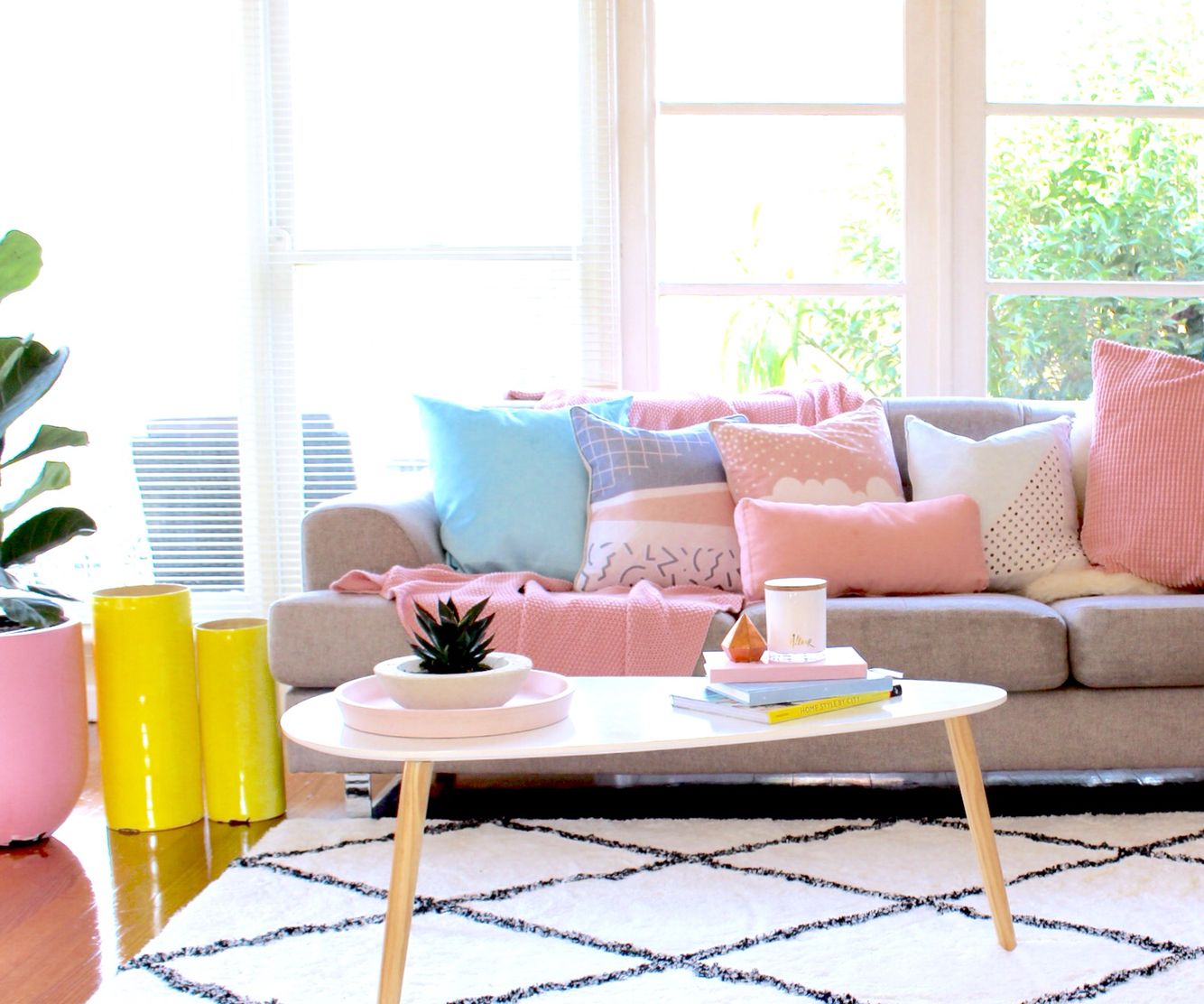 pastel coloured loungeroom decor with cushions and sofa